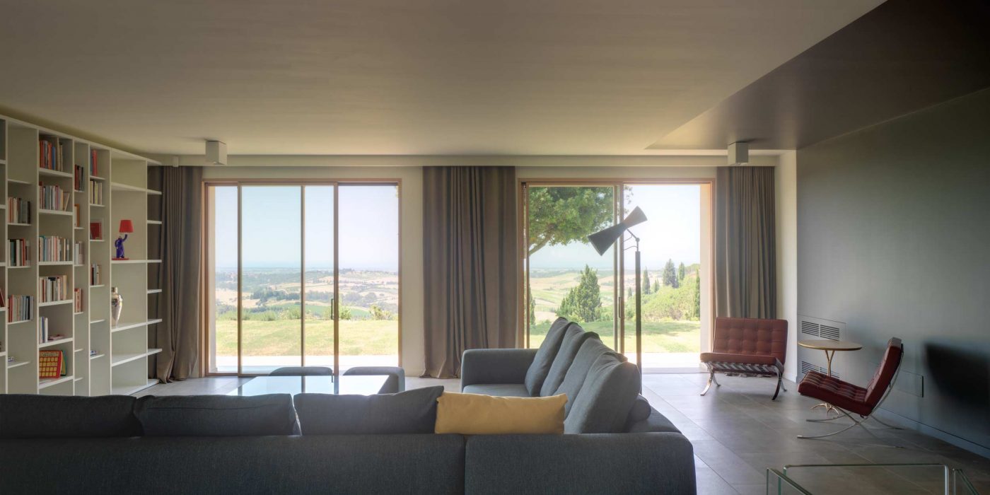 View of the living space of Villa Pisa with wooden lift and slide doors